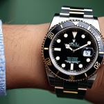 **

A close-up shot of a Rolex Submariner on a wrist, emphasizing its timeless elegance and classic design. The background should be subtly blurred, hinting at a sophisticated setting. Focus on the 904L stainless steel and the overall feeling of understated luxury.

**