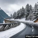 스위스 운전 시 주의할 점 - A detailed scene of a Swiss alpine mountain road during winter, showing a narrow, winding road with ...